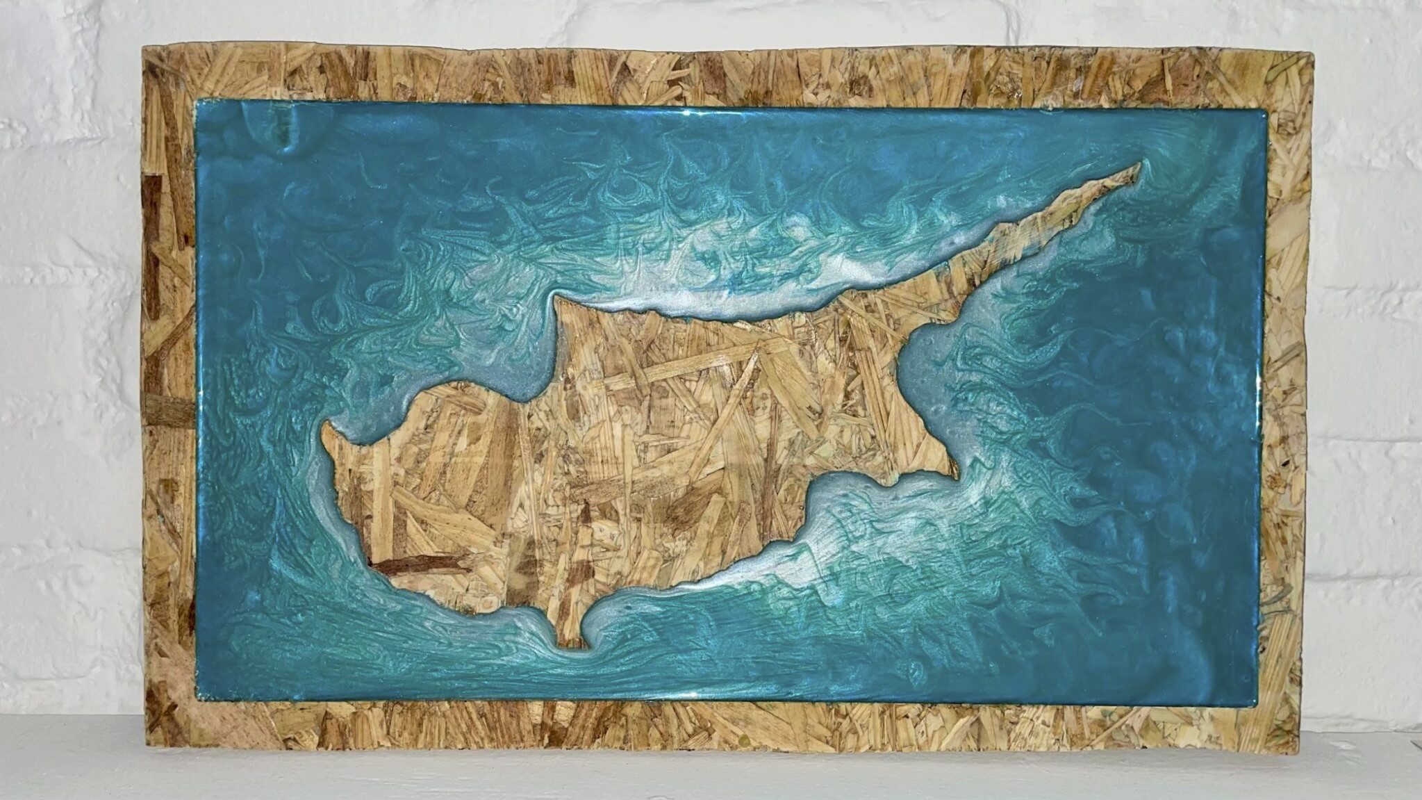 Cyprus milled out with blue resin surrounding the island