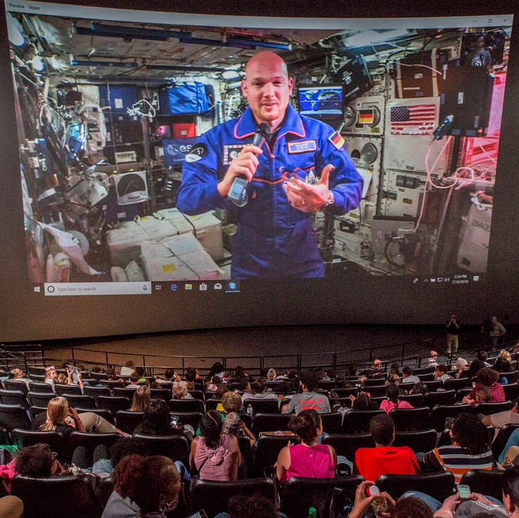 Students watch as European Space Agency Astronaut Alex Gerst floats aboard the International Space Station. Gerst answered about a dozen questions from regional students.